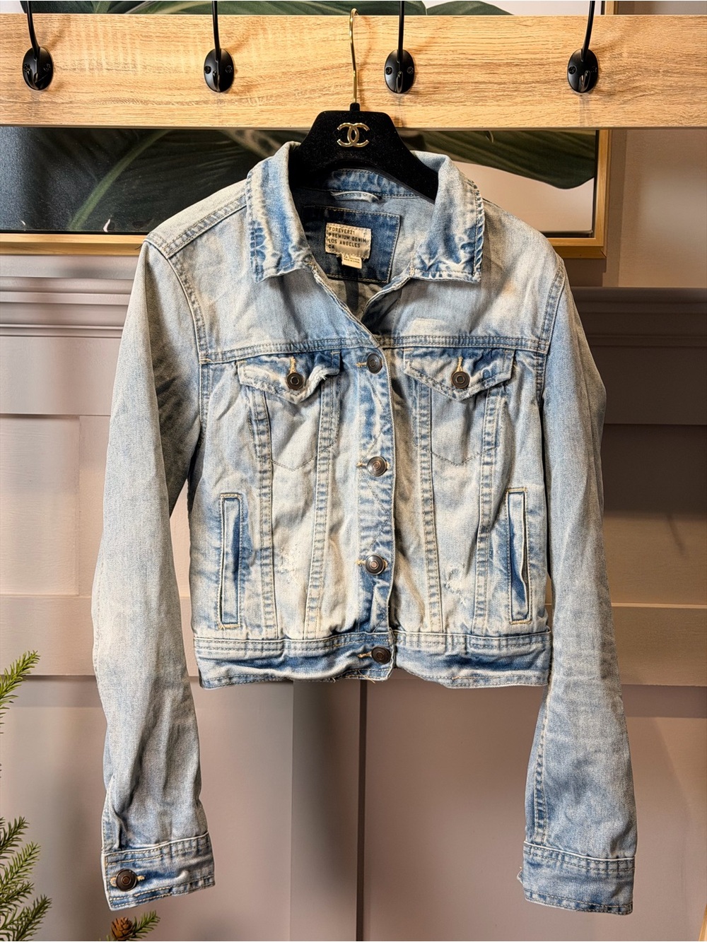Light wash distressed denim jacket from Forever 21 featuring classic button-flap